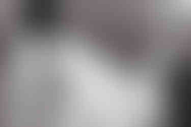 bride's veil blowing in the wind and groom looking at bride in joshua tree wedding