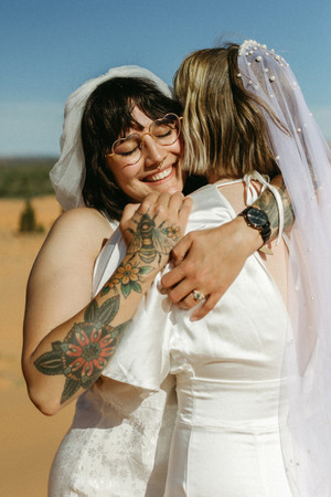 coral pink sand dunes state park lesbian elopement couple embracing with smiles