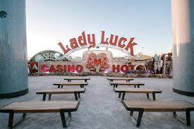 the neon museum ceremony space in from of lady luck sign at las vegas wedding venue