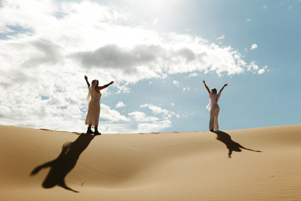 coral pink sand dunes state park lesbian elopement couple dancing on sand dunes