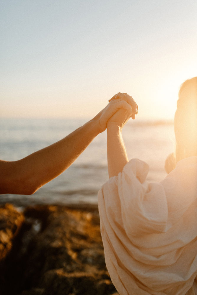 close up holding hands at sunset laguna beach