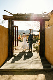 couple walking through entrance at sacred sands wedding venue in Joshua Tree