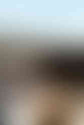 bride wearing cosmic custom wedding dress sitting in outdoor bathtub looking out at desert at sacred sands wedding venue in Joshua Tree