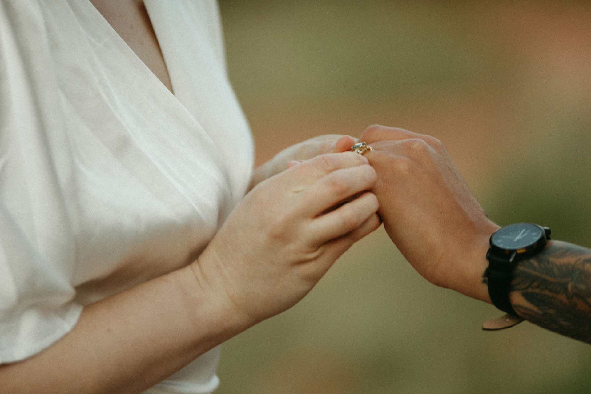 bride placing ring on other bride's hand during zion national park elopement