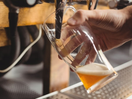 side view of a refreshing glass with beer on a table