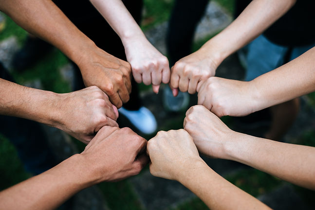 close-up-students-standing-hands-making-fist-bump-gesture.jpg