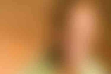 A man with a short haircut makes a facial expression of surprise or confusion, wearing a green shirt.