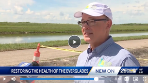 The Everglades Foundation's Chief Science Officer, Dr. Steve Davis, is interviewed by WPBF News near the Everglades Agricultural Area (EAA) Reservoir. "Restoring the Health of the Everglades" displayed. Sunny day, grassy background.