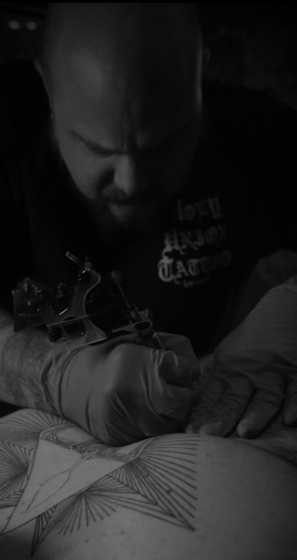 tj russo tattooing a chest piece on a client