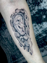 Abstract shell on the inside of the forearm with minimalist linework and gradient shading.