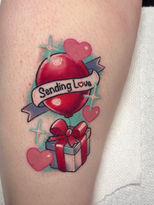 Neo traditionall tattoo with banner that reads "sending love" on the outside of the calf.