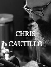Chris Cautillo tattooing holding a tattoo machine