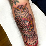 Traditional Owl Tattoo holding an Eye of Providence on the forearm