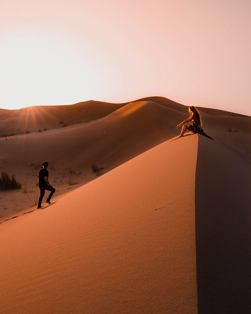 couple-sitting-sahara-desert-morocco-sunset.jpg