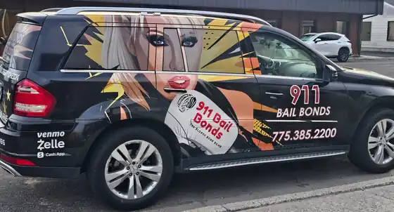 Deborah's black Mercedes wrapped in 911 Bail Bonds graphics with the phone number (775) 385-2200