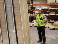 Lundell panel in a factory with a man who looks happy