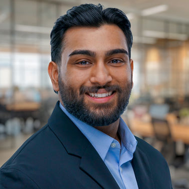 Corporate headshot of smiling professional, studio setting 