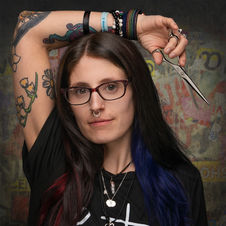 Creative portrait of a woman with dark hair and glasses, artistic background and styling