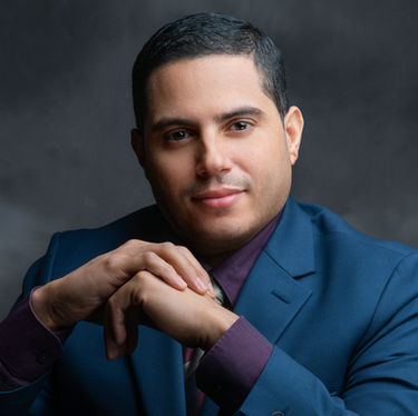 Executive headshot of man in suit, confident expression