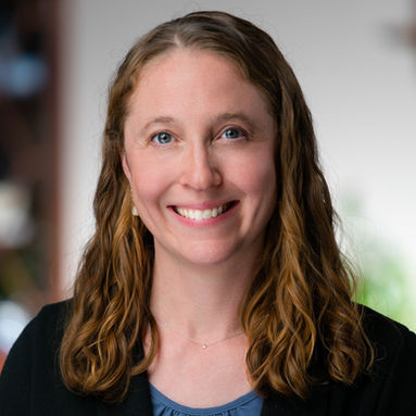 Professional headshot of business woman against home environment background