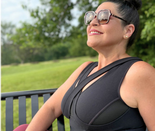 Woman wearing Embrago bra-free support top with relaxed, natural posture