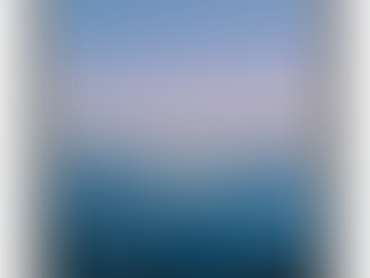 Astronaut floating on calm ocean at sunset with a pastel sky. The mood is peaceful with deep blue water and distant shoreline.