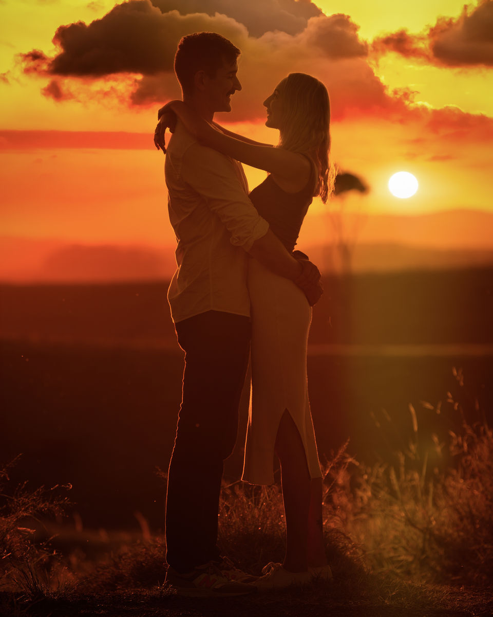 Victoria Shamrock, Shamrock Space Studio, proposal or engagement photograph of silhouettes of a young beautiful couple looking at each other and enjoying an amazing romantic sunset in Millaa Millaa, Atherton Tablelands, Queensland, Australia.