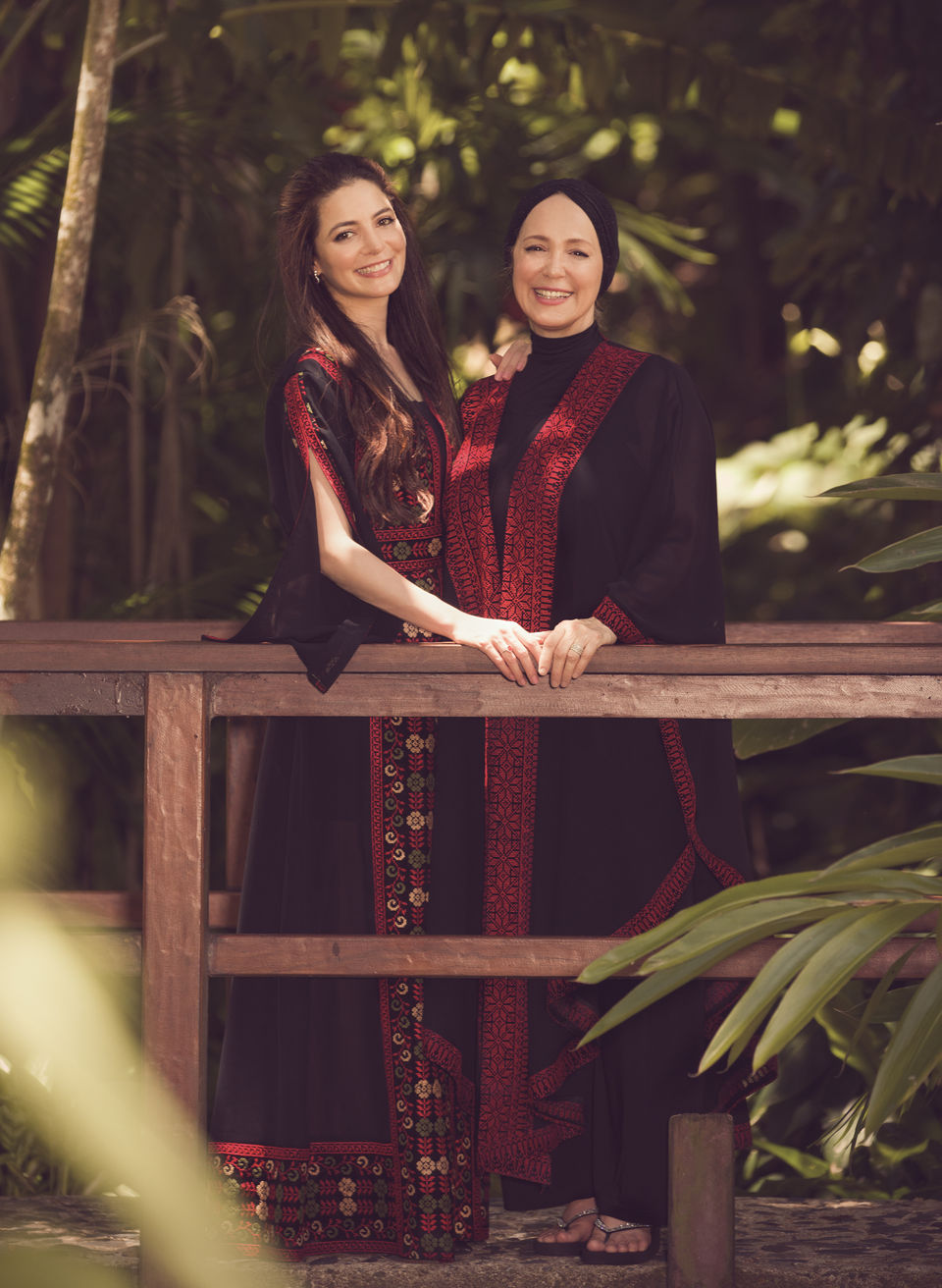 Family Portrait of mother and her daughter dressed in traditional middle east clothes, outfits smiling and posing in the tropical garden. Family Photographer in Cairns. Shamrock Space Studio