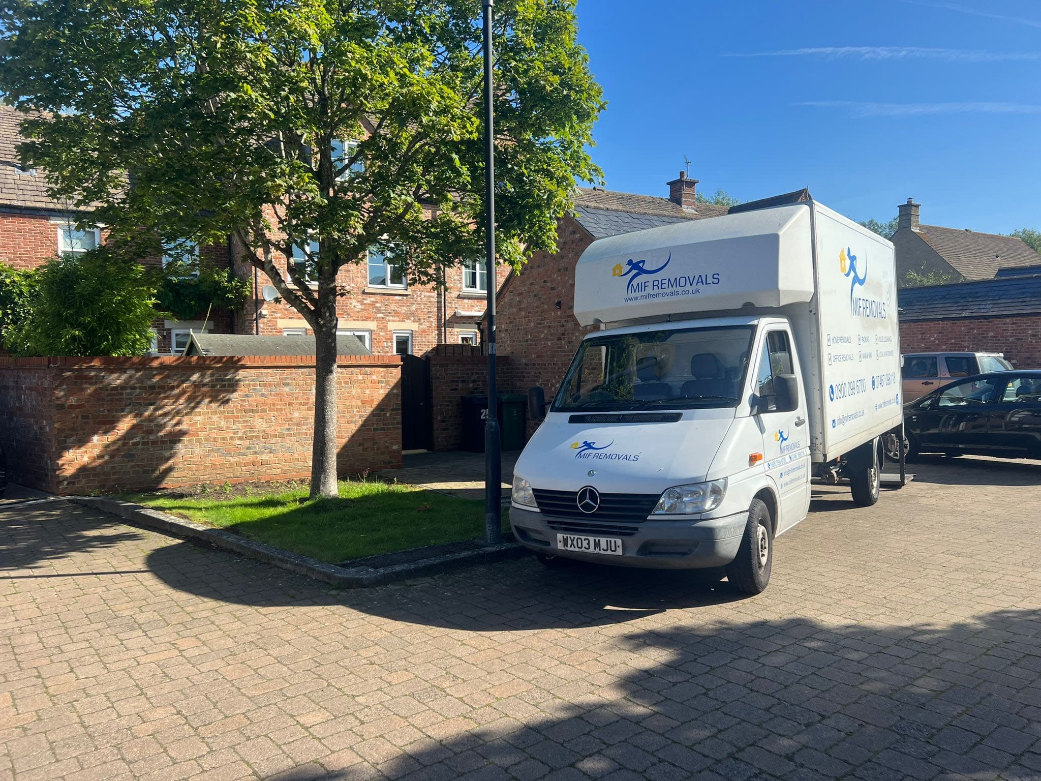 Professional movers from MIF Removals packing computers and office supplies for a safe business relocation