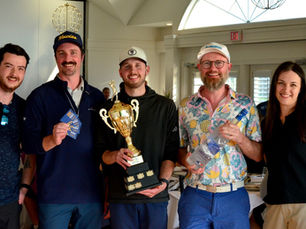 A group of people posing with a trophy.