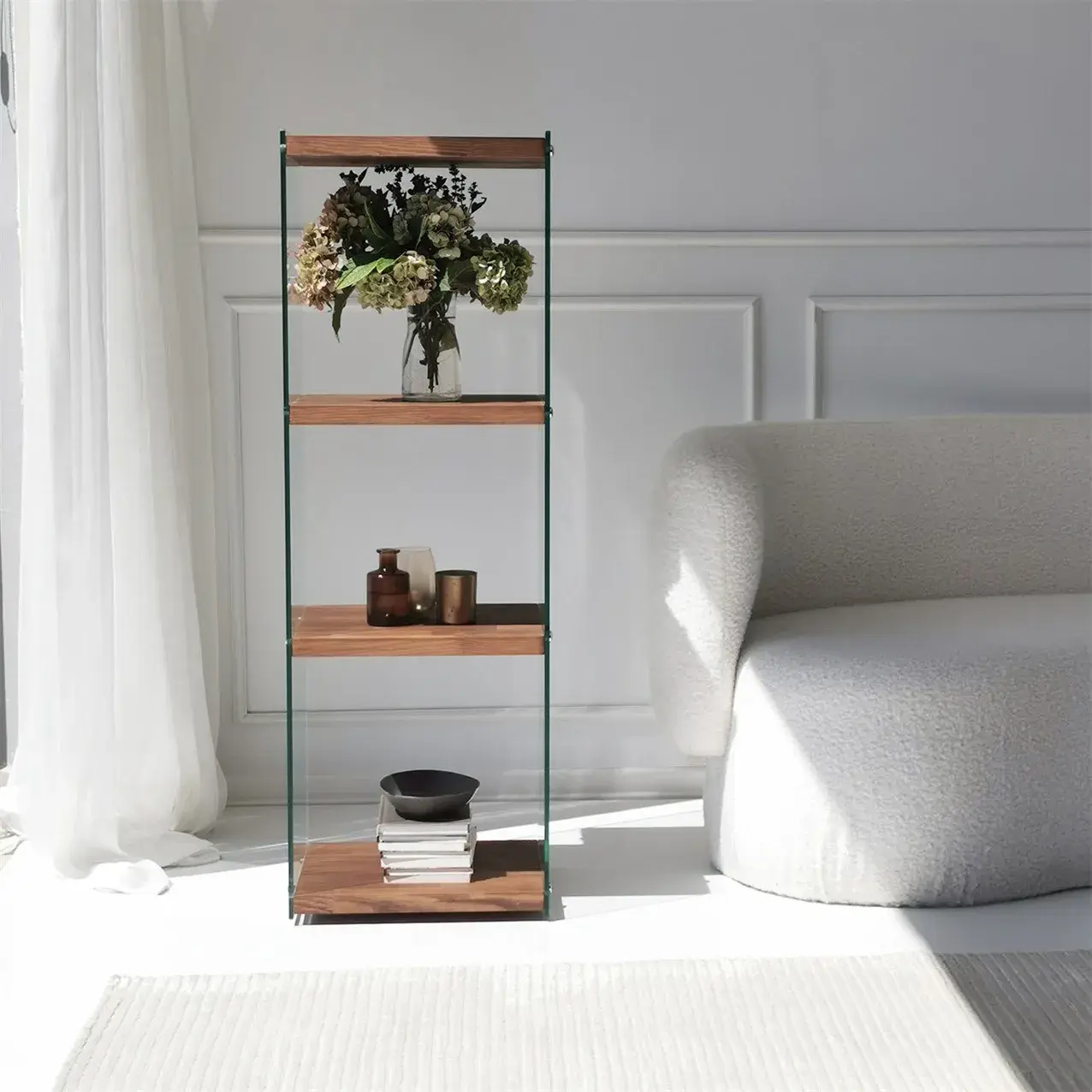 Front view of full-height 3‑tier walnut shelf unit with clear glass panels
