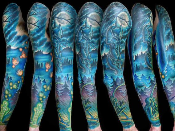 Illustrative color sleeve tattoo featuring a harpist, fireflies, a wolf beneath a tree, and a starry night sky by Joe Swider in Connecticut