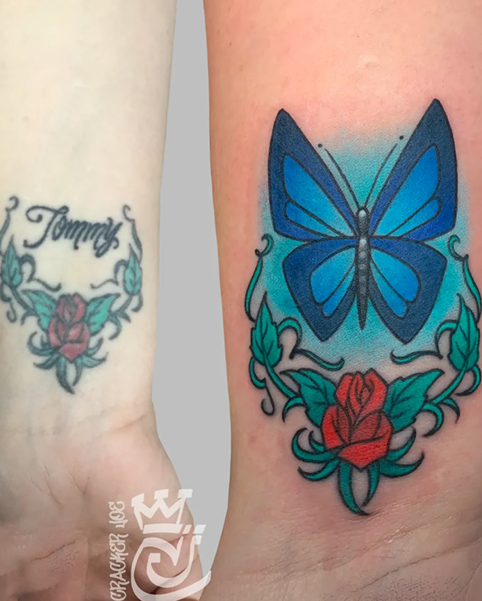 Blue butterfly wrist cover up tattoo in Western Connecticut replacing a name tattoo, with reworked rose and vine floral design.
