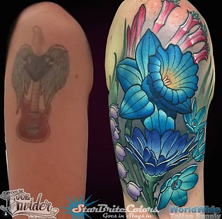 Floral half sleeve cover up tattoo transforming a blurry guitar with wings into blue daffodil and floral design on upper arm.