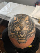 Black and grey head tattoo of a tiger done by Cracker Joe Swider in New Milford, CT