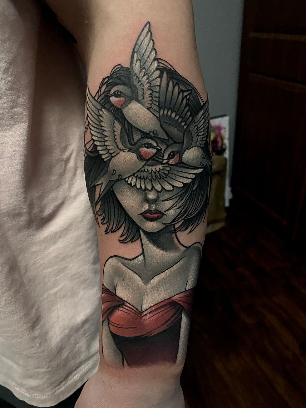 Black and grey portrait tattoo of a woman with birds covering her face in a detailed realistic style.