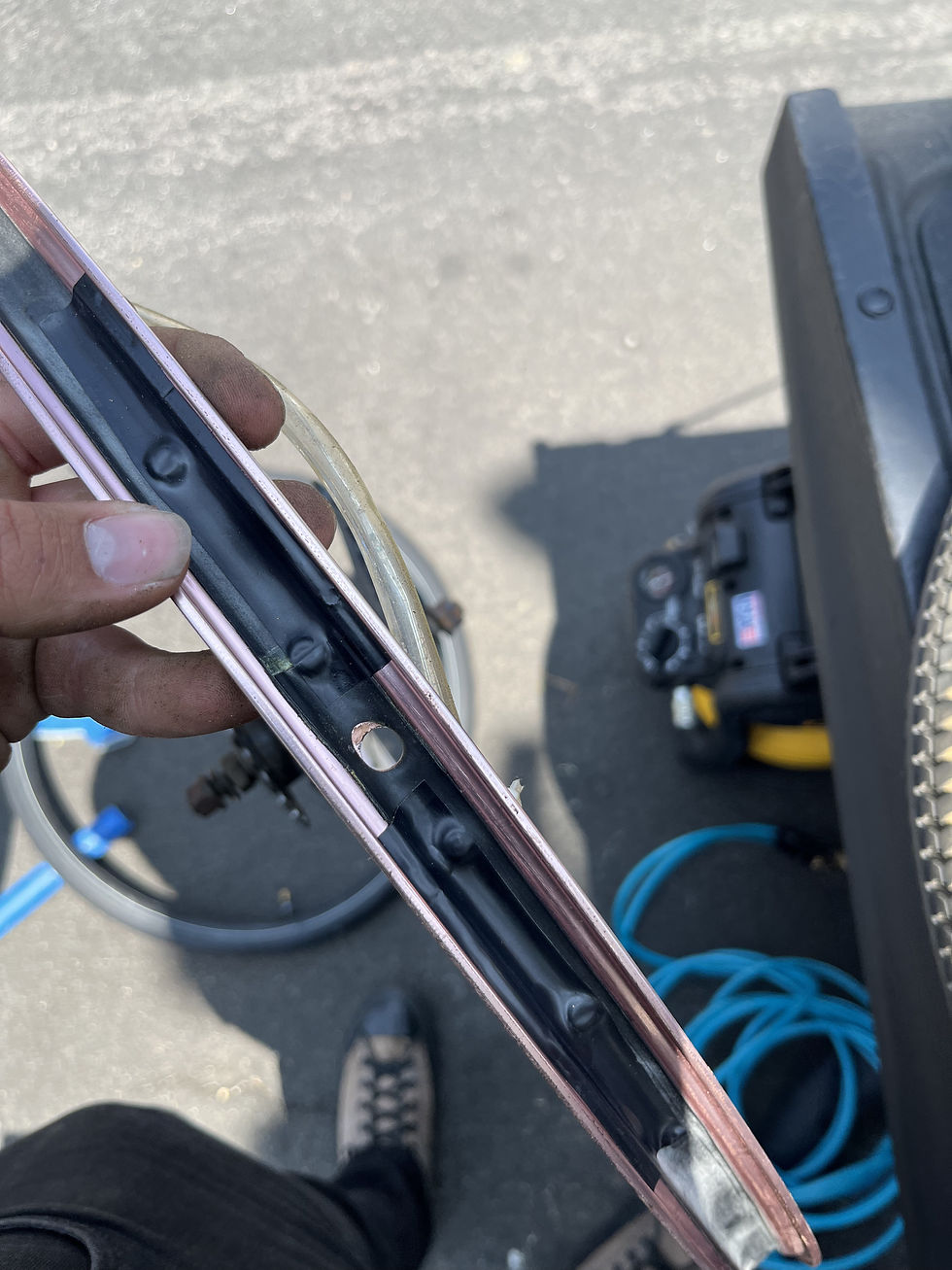 Rim strip inspection and adjustment during a CycloPunk mobile bicycle flat tire repair.