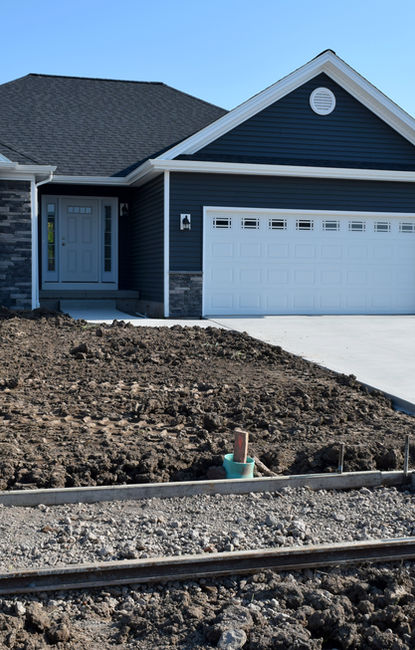 Home driveway under construction with rebar grid and concrete crew
