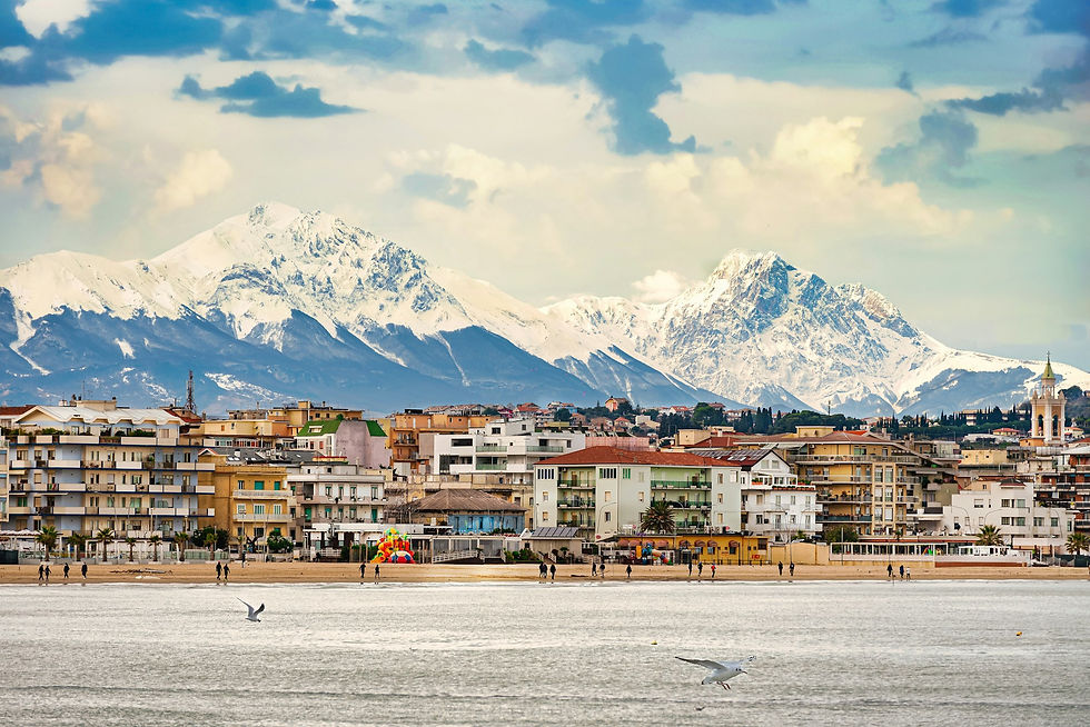 Pescara with mountains behind https://unsplash.com/@mimmosigi?utm_source=unsplash&utm_medium=referral&utm_content=creditCopyText