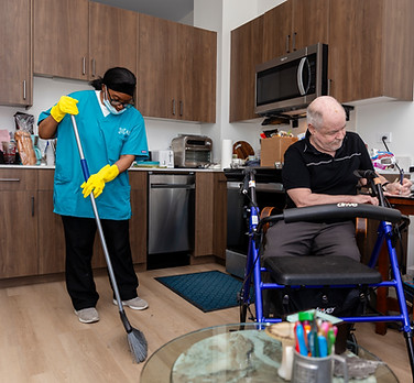 ASI worker brooming next to a senior