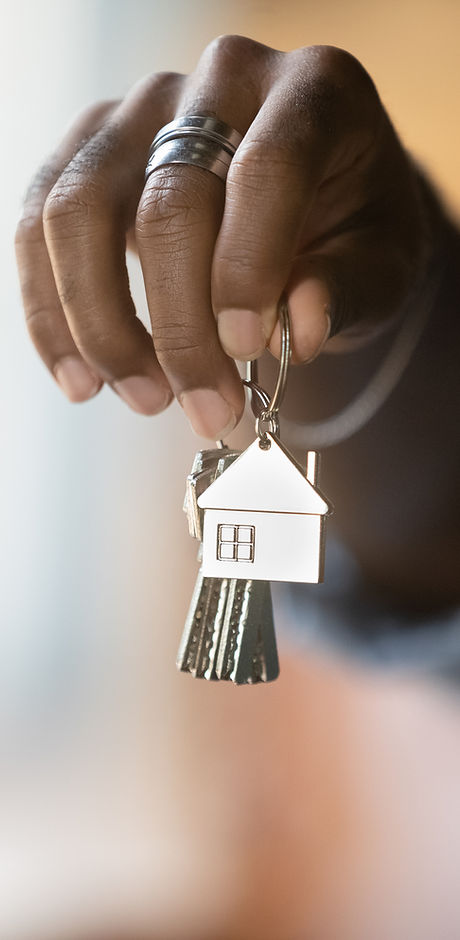 Welcome to new house. Close up of young african american man hand hold bunch of keys. Crop
