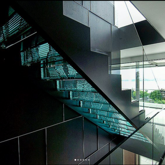 glass sculpture embedded into a modern black staircase