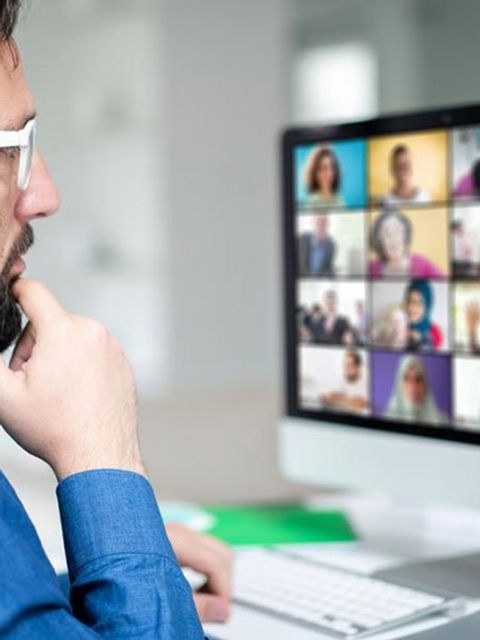 Man Watching a Zoom Meeting
