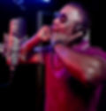 Terrence Bell is wearing headphones in front of a microphone.