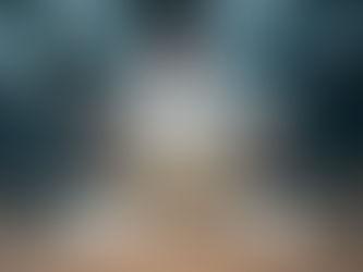 Pizza chef stretching dough on floured table