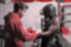 male coach preparing a boxer for combat