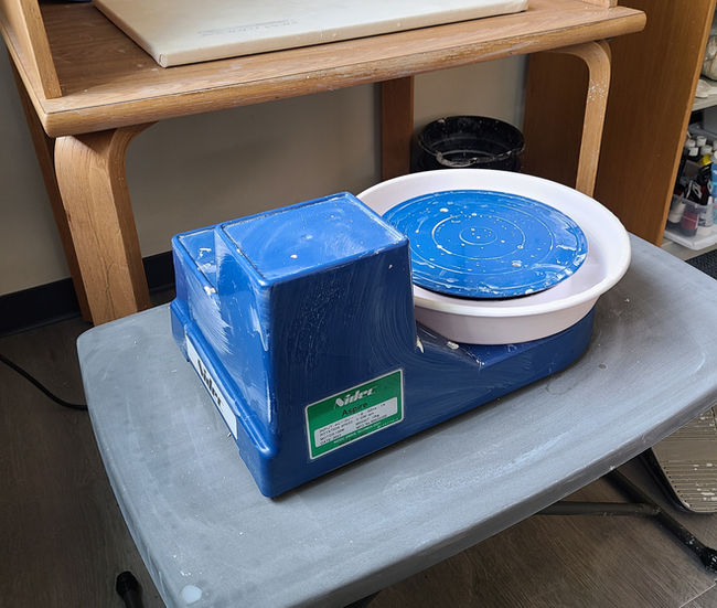 Nidec Aspire Pottery Wheel on a small table in the Innovation Lab.