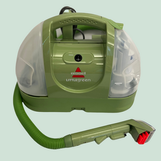 A Bissell Littlegreen portable spot cleaner with a carrying handle and extendable hose.