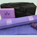 A rolled up purple CleverYoga yoga mat and supplies.