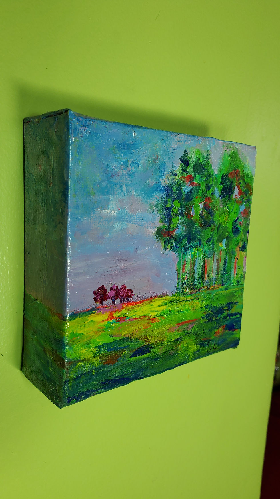 small red trees near a green forest painting